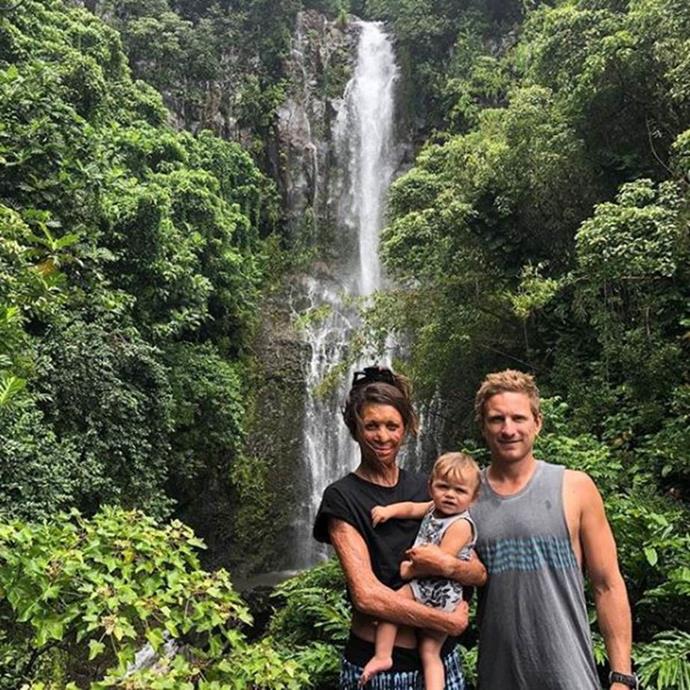 Turia Pitt, Michael Hoskin and Hakavai in front of a waterfall in Hawaii.