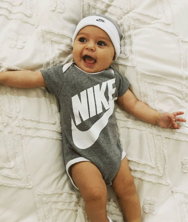 Sam and Snezana Wood's daughter Charlie Lane in Nike onesie.