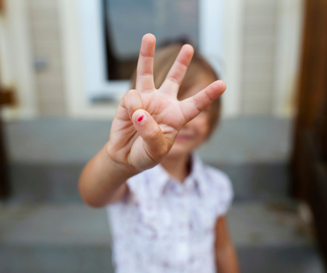 three year old holding up three fingers